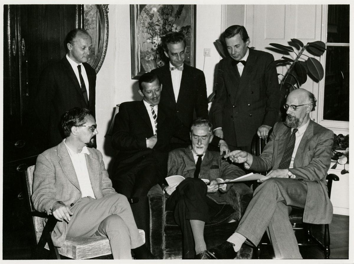 <p>Escher with his fellow board members of 'De Grafische', July 1960. From left to right, standing: Gerd Arntz, Jan Bezemer, Pam Rueter. Seated: Lou Strik, Cor Basart, M.C. Escher and Hans van Dokkum. For many years Escher was the archivist of this association to stimulate Graphic Arts.</p>